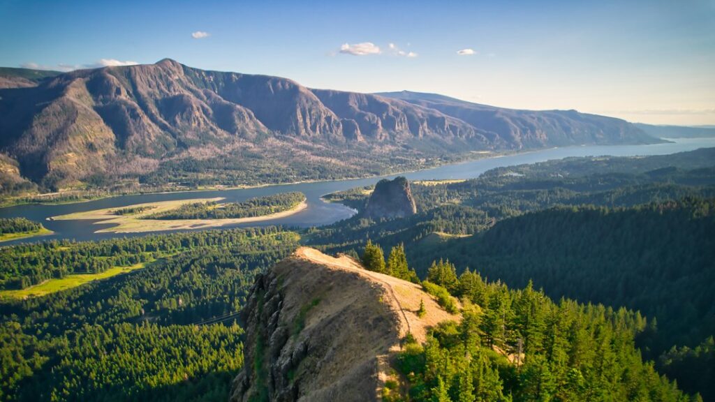 Columbia River winding through wooded mountains and rocky bluffs.